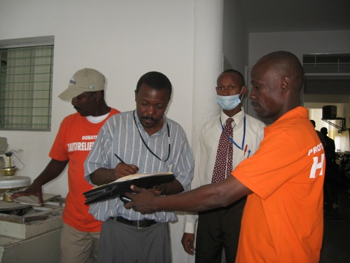 November 25, 2010: Mr. Origen Jean Claude from CTC Cholera Treatment Center, Centre L'OFATMA signing for receiving the donation of 1 barrel of bleach for centre L'OFATMA to help fight cholera in Haiti.